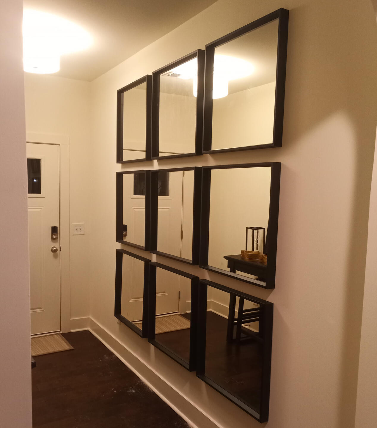 Handy Dandy Atlanta — nine black-framed square mirrors installed in a 3x3 grid on an entry hallway wall