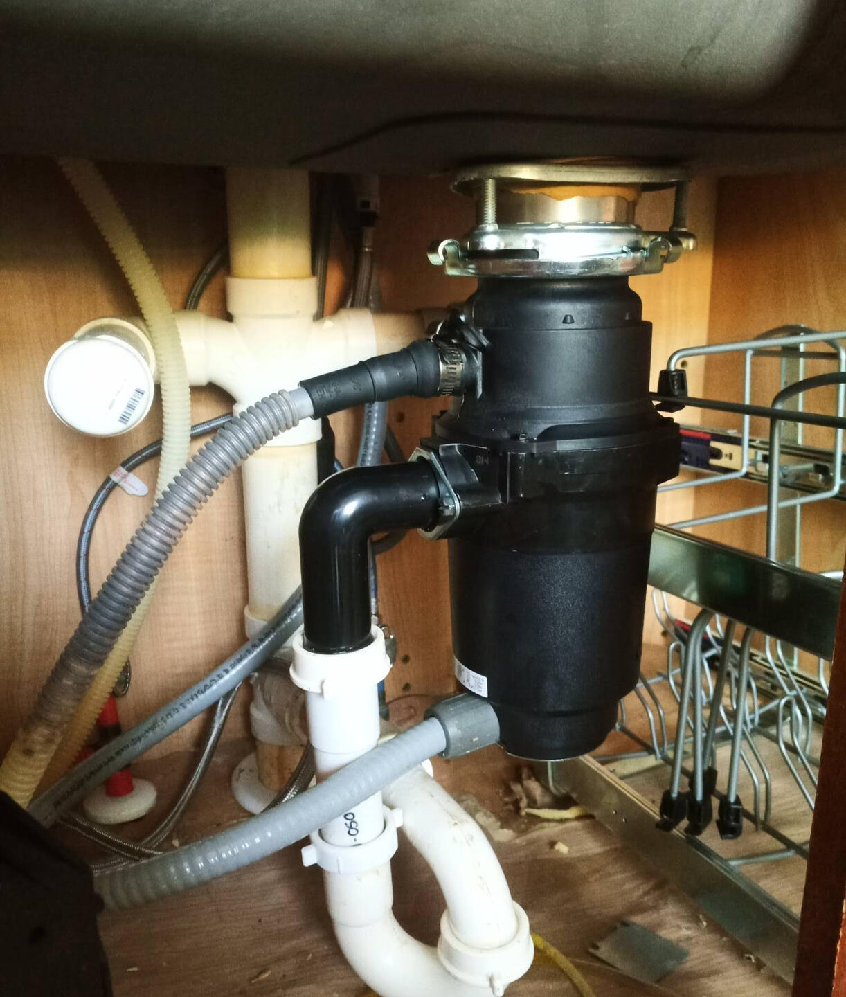 Handy Dandy Atlanta — new under-sink InSinkErator garbage disposal with fresh P-trap and flex line supply in a kitchen cabinet
