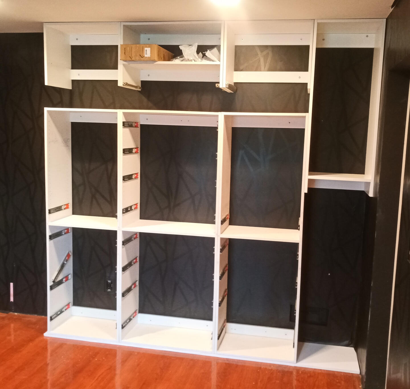 Handy Dandy Atlanta — custom floor-to-ceiling built-in cabinet unit with drawer slides installed and ready for door panels
